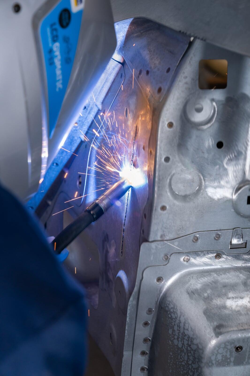 A pulse MIG arc running a seam on a vehicle panel